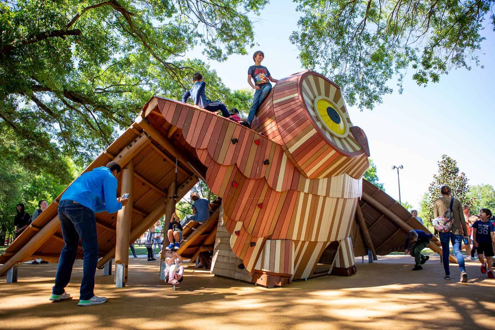 boy sitting on top of owl playground